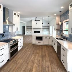 Affordable Remodeling Solutions - Open concept living and kitchen area. We removed a wall separating the living area and kitchen with new kitchen layout, quartz and tile.