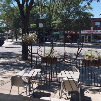 Knuckle Sandwich - Window graphic, front patio and view of Coxwell Avenue - Poutineries Near Me - Toronto, Ontario