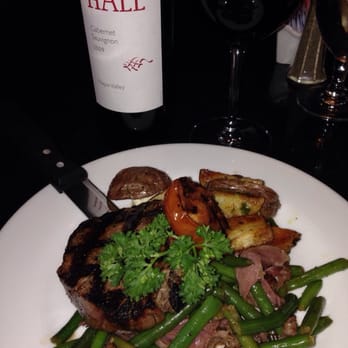Bistro 6k - a plate of food and a bottle of wine - New American Near Me - Huntsville, Alabama