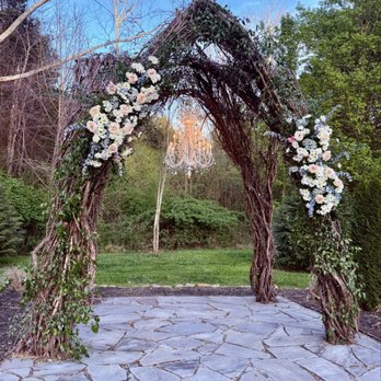 Ramble Creek Vineyard & Events - Vine arbor outdoor wedding ceremony site with flowers and white chandelier, evening time, moon in background - Venues & Event Spaces Near Me - Athens, Tennessee Ramble Creek Vineyard & Events - Vine arbor outdoor wedding ceremony site with flowers and white chandelier, evening time, moon in background - Venues & Event Spaces Near Me - Athens, Tennessee