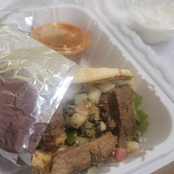 Crazy Pita - BRAISED LAMB PITA: Gyro with braised lamb, feta salad, wrapped in pita. Served with hot oil and tzatziki sauce. $8.99, $11.99 with side. - Mediterranean Near Me - Port St Lucie, Florida