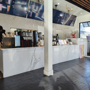 TP Tea - Inside - A bubble tea shop interior featuring a white marble counter, digital menu screens, and coffee-making equipment, with a bright, clean design. - Bubble Tea Near Me - Millbrae, California