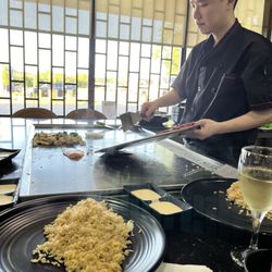 Umami Japanese Steakhouse - The chicken and sirloin being added to the habachi.