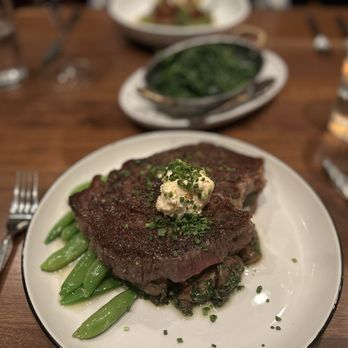 Ramble Room - ribeye special with a side of spinach and kale in the background. Looks better than it is - New American Near Me - Dallas, Texas