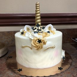 a white cake with a gold horn a white cake with a gold horn