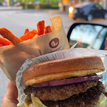 A&W - a person holding a hamburger and fries - Fast Food Near Me - Coquitlam, British Columbia A&W - a person holding a hamburger and fries - Fast Food Near Me - Coquitlam, British Columbia