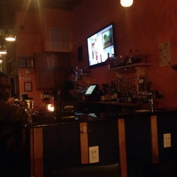 The Elroy - a man sitting at a bar watching tv - Lounges Near Me - Washington, DC, District of Columbia