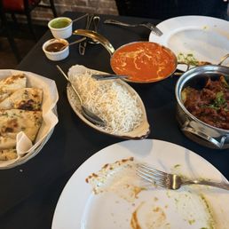 Garlic naan  Basmati rice (white rice) Orange plate was Butter Chicken The right plate was kadai goat