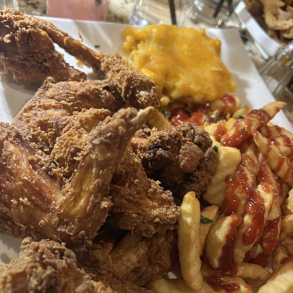 Fried chicken wings, mac, and French fries Fried chicken wings, mac, and French fries