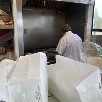 Tacos El Comal - a man preparing food in a kitchen - Mexican Near Me - Sisters, Oregon Tacos El Comal - a man preparing food in a kitchen - Mexican Near Me - Sisters, Oregon