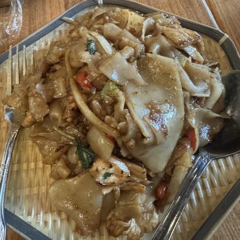 Thip Khao - Kee Mao - A dish featuring wide rice noodles with vegetables and sauce, served on a metal tray at a Laotian restaurant. - Laotian Near Me - Washington, DC, District of Columbia