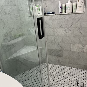 Denis Design - Plastic tub and shower replaced with full marble tile walk in shower. - Tiling Near Me