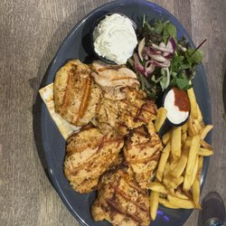Nosta restaurant - Chicken skewers with chips & salad. Paid €3 extra for the tiny Tzatziki (white blob in photo).