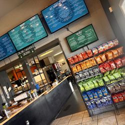 Full Belly Deli - Mill Street - Front lobby area. Register to the left. Seating area in back