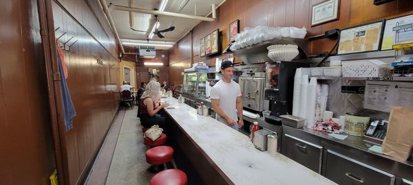 Photo of Duly's Place - Detroit, MI, US. a man standing at the counter