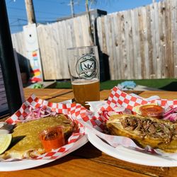 Hefeweizen beer with the taco caterers. Love the outdoor seating here. Tasty beer and very cheesy birria tacos.