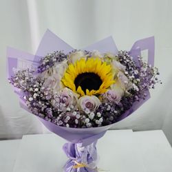 Estrella's Flower Shop - Light pink roses and a sunflower in the center.
Order light purple roses at Estrella's Flower Shop.
