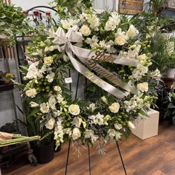 Coady Florist - Classic White Sympathy Wreath honoring a loved one for a funeral service. Delivery to Belmont, MA