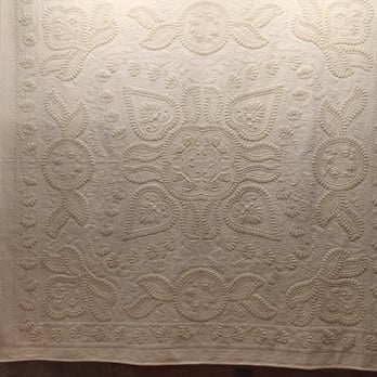 Rocky Mountain Quilt Museum - Hard to see but this was a gorgeous ivory quilt with some of the detailing done with gold thread - Museums Near Me - Golden, Colorado Rocky Mountain Quilt Museum - Hard to see but this was a gorgeous ivory quilt with some of the detailing done with gold thread - Museums Near Me - Golden, Colorado