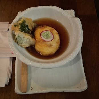 Wasan Brooklyn - Corn Agedashi - A Japanese-style dish with a fried tofu ball topped with a radish slice and wasabi, served in soy sauce in a ceramic bowl. - Japanese Near Me - Brooklyn, New York