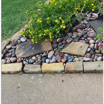 Helms Trail Tree Trimming and Property Management - River rock in front flowerbed - Property Management Near Me