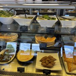 La Baguette - Salad, Tabouli, Penne Florentine, Kale Quinoa, Spinach and Tomato Quiche, Dolmades, & Hummus.