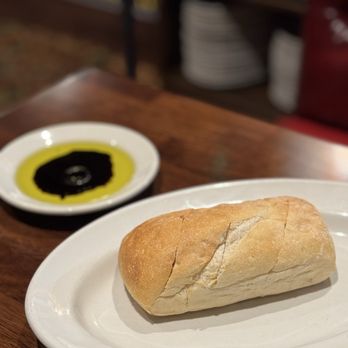 Buca di Beppo Italian Restaurant - Bread and olive oil and vinegar - Italian Near Me - San Diego, California Buca di Beppo Italian Restaurant - Bread and olive oil and vinegar - Italian Near Me - San Diego, California