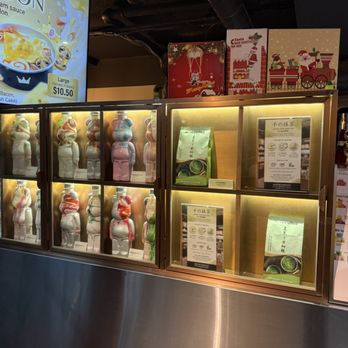 Royaltea - Bear Bottle - A glass display case contains multiple bear-shaped ice cream or dessert figures in various colors, illuminated from within, at a shop in Toronto. - Bubble Tea Near Me - Toronto, Ontario