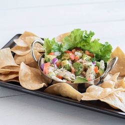 Sea Island Shrimp House - Fresh, citrusy mahi ceviche with cilantro, veggies, and our hand-made tortilla chips. Made daily at Sea Island Shrimp House in Creekside.