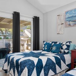 Conroe Lakefront Cottage - Coastal comfort meets spacious design in this bright guest room with two double beds--perfect for family to rest and recharge by the lake.
