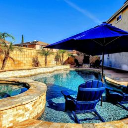 a pool with chairs and an umbrella
