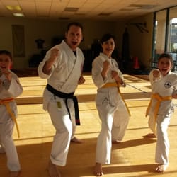Pacific Martial Arts - Chief instructor Jason Knight with 3 of his students