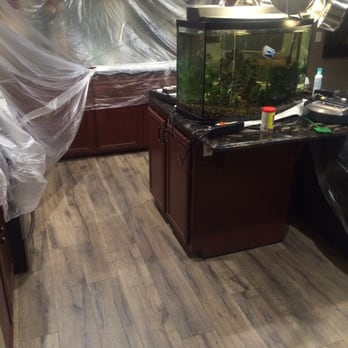 Garcia's Flooring - Kitchen with everything still covered up after day one. - Flooring Near Me