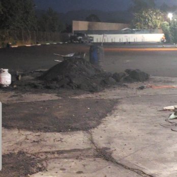 Asphalt Paving Services - hardened cooled asphalt left out in the middle of the parking lot for days. - General Contractors Near Me