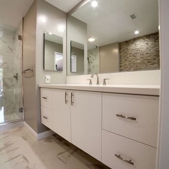 Grid Builders - a bathroom with a double sink and a walk in shower - General Contractors Near Me Grid Builders - a bathroom with a double sink and a walk in shower - General Contractors Near Me