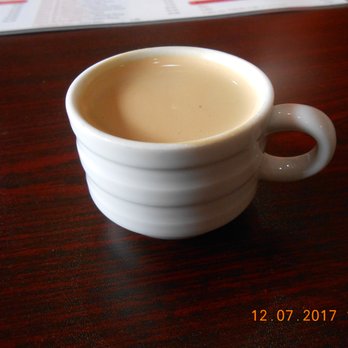 Cafeteria El Chocolate - a cup of coffee on a table - Pizza Near Me - Cape Coral, Florida
