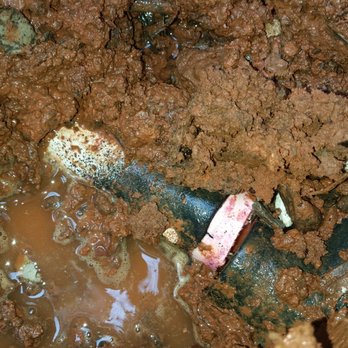 Irrigation Technicians - a broken pipe in the mud - Landscaping Near Me Irrigation Technicians - a broken pipe in the mud - Landscaping Near Me