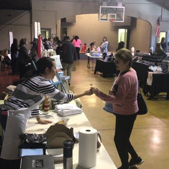 Get Tamales - a group of people standing around a table - Caterers Near Me Get Tamales - a group of people standing around a table - Caterers Near Me