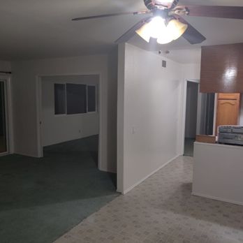 Luc's Construction - View of living room and opening to family room (before) - General Contractors Near Me