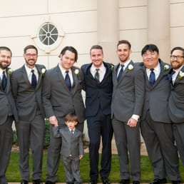 Dark blue suit with a grey tie for the groom/ dark grey suits with a blue tie for the groomsmen. Dark blue suit with a grey tie for the groom/ dark grey suits with a blue tie for the groomsmen.