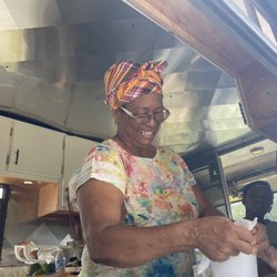 Caribbean Signature Cuisine - Owner always smiling with the patrons.
