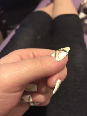 Photo of Pro Nails - Sidney, OH, US. Uneven color and top coat with messy design