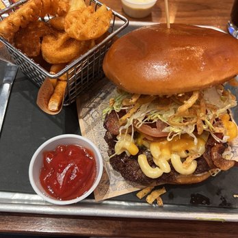 Guy Fieri's Branson Kitchen + Bar - This is a smash burger with bacon, onion straws, LTOP (lettuce tomato onion & pickle) with Mac & cheese and donkey sauce. - Bars Near Me - Branson, Missouri
