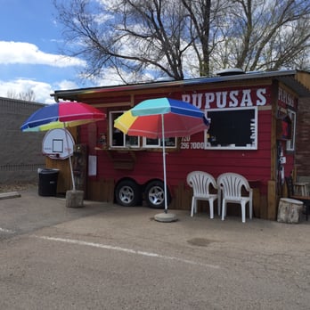 Pupusas - a dog sitting under umbrellas in a parking lot - Salvadoran Near Me - Louisville, Colorado Pupusas - a dog sitting under umbrellas in a parking lot - Salvadoran Near Me - Louisville, Colorado
