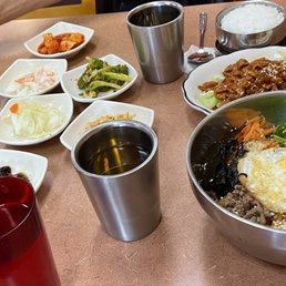 Lunch special of bibimbap (front) & pork bulgogi (behind) with complimentary side dishes (banchan) & tea/ water Lunch special of bibimbap (front) & pork bulgogi (behind) with complimentary side dishes (banchan) & tea/ water