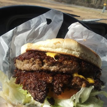 Dairy Treet - a hand holding a hamburger - Burgers Near Me - Waldo, Arkansas