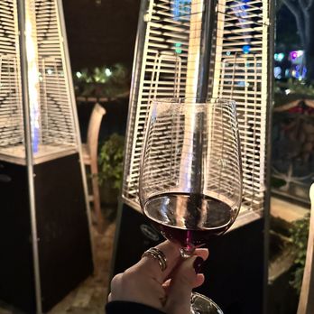 Pony Club Bar - a person holding a glass of wine - Wine Bars Near Me - Paso Robles, California Pony Club Bar - a person holding a glass of wine - Wine Bars Near Me - Paso Robles, California