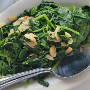 Wolfgang's Steakhouse - Spinach with garlic flakes. - Steakhouses Near Me - Honolulu, Hawaii