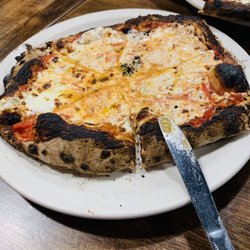 Pyra Pizzeria - Margherita. Basil under cheese. Crust is a little overdone, to say the least.