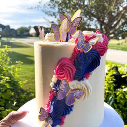 Sugar on Top Dessert Studio - Almond flavored cake with raspberry and buttercream filling designed with pretty flowers and butterflies